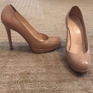 Nude Christian Louboutin patent leather heel.